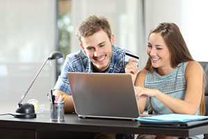 Couple with laptop at desk