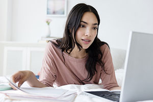 Woman looking at laptop